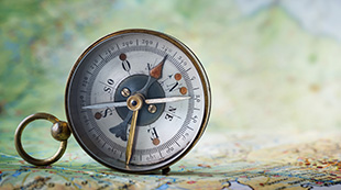 Key Advisors - compass pointing north on a map